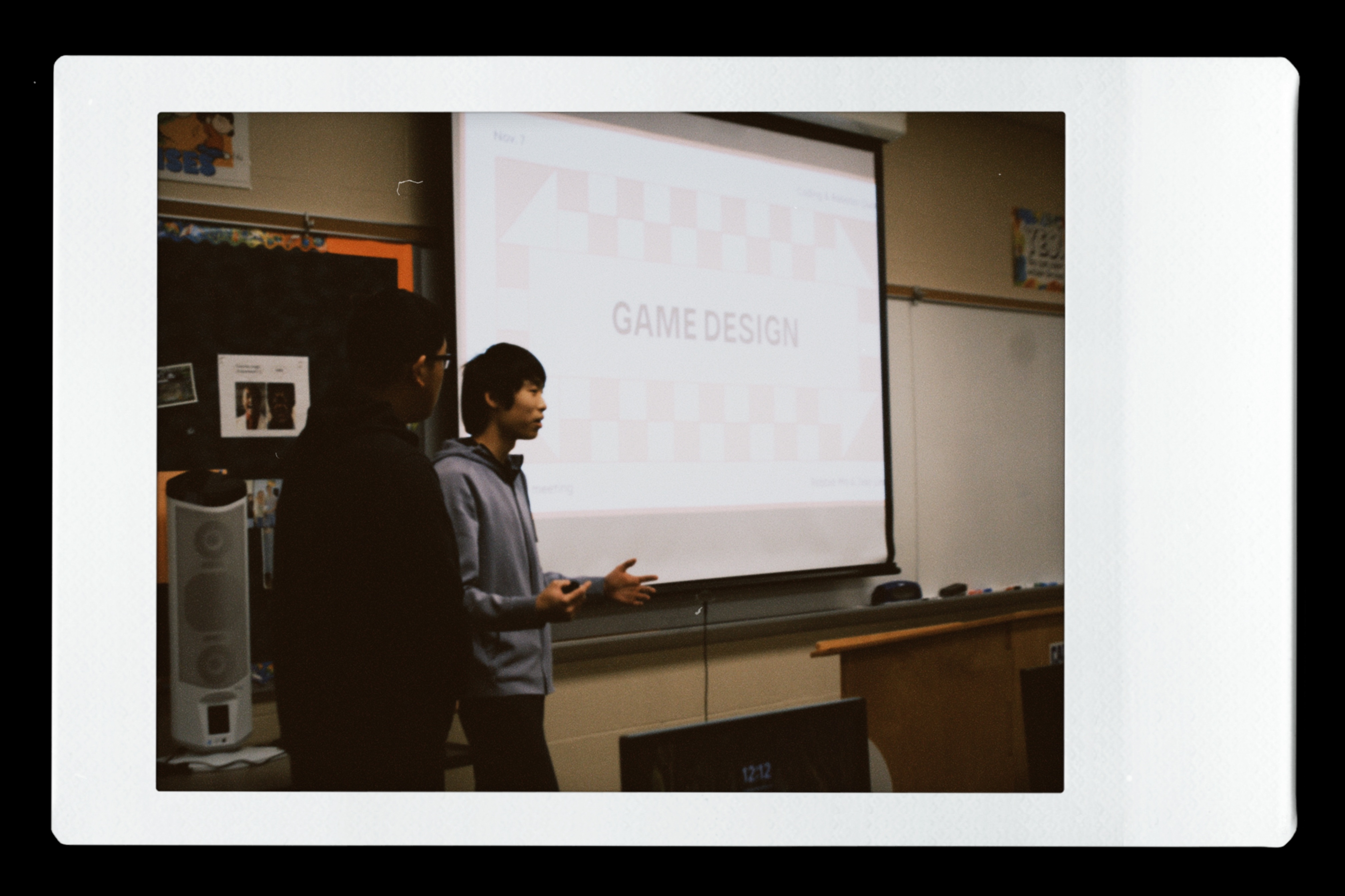 Students presenting in front of a screen